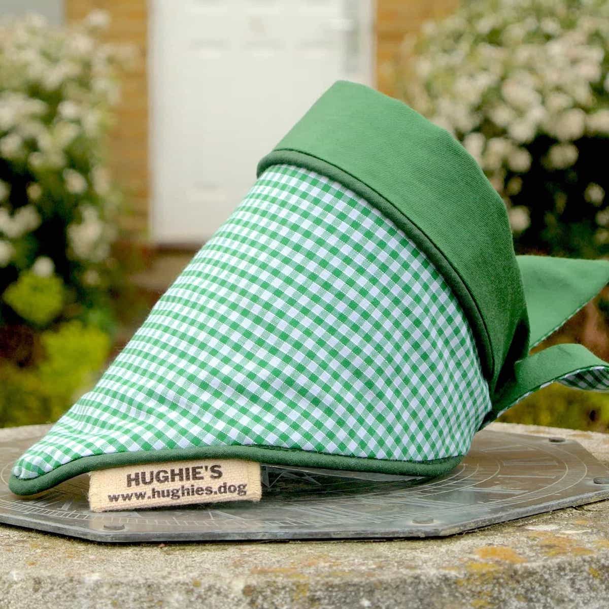 Emerald Green Gingham Tie-on Dog Bandana (reversible) photographed placed on a weather dial in a country garden