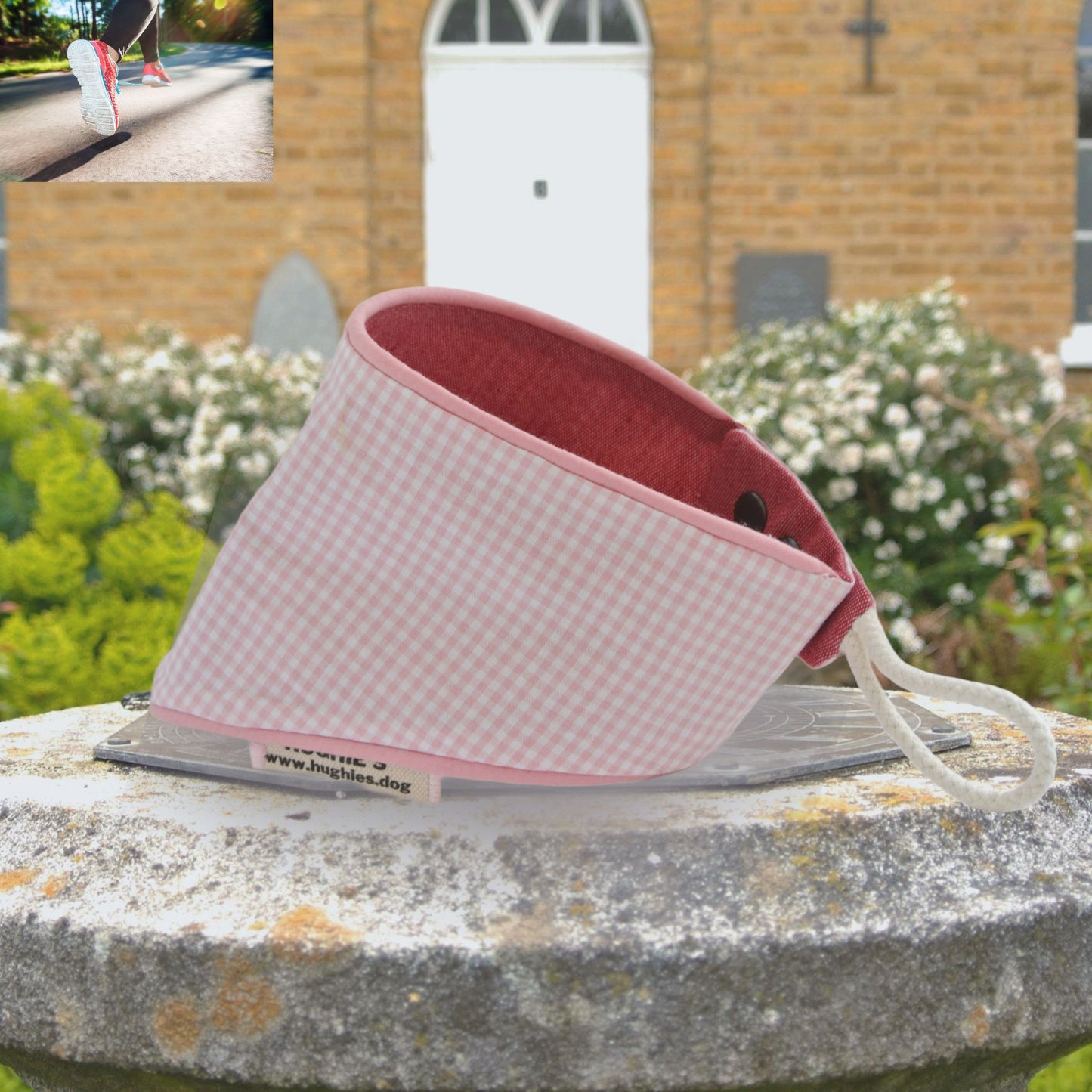 Pink Gingham snap-on Dog Bandana (reversible) photographed placed on a weather dial in a country garden