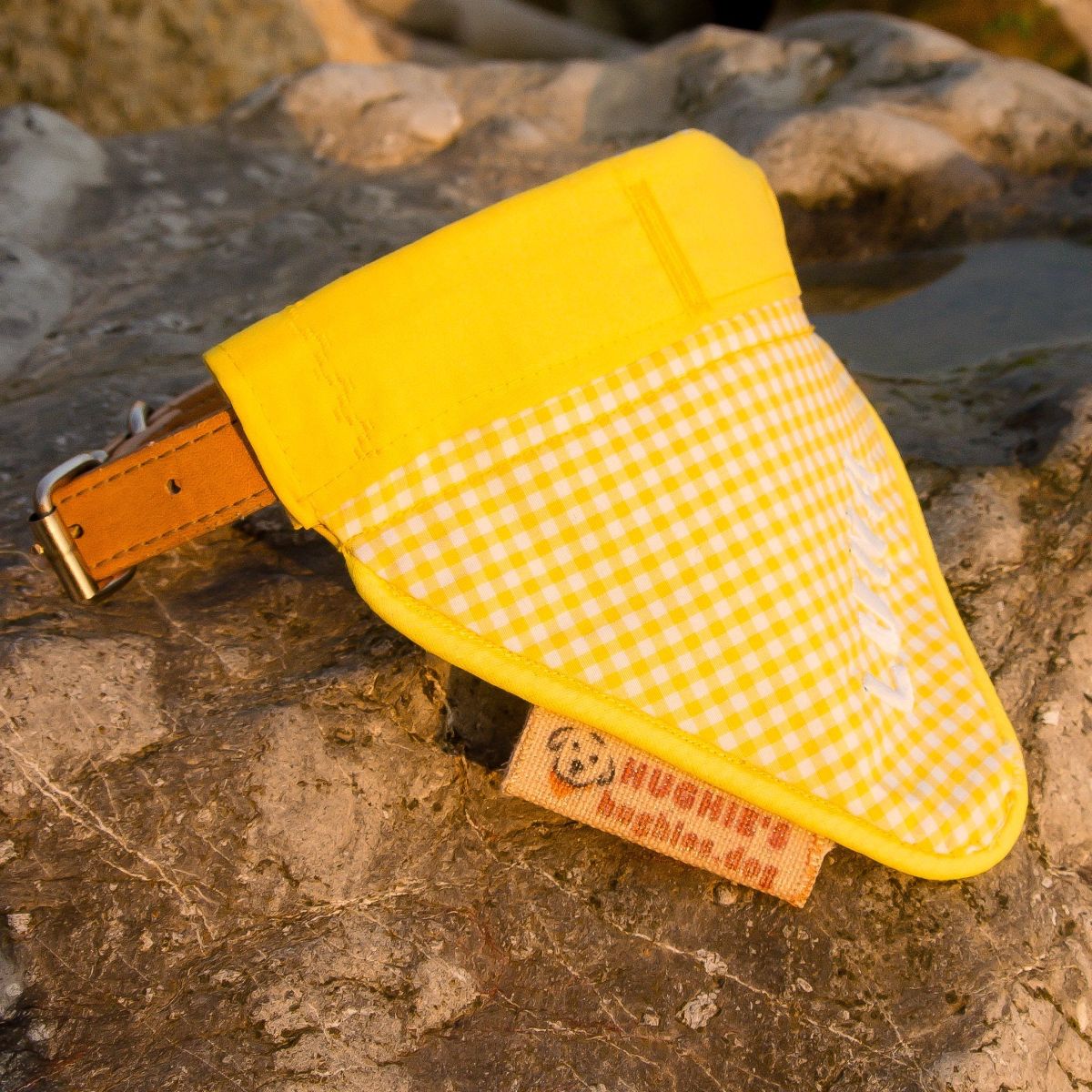 Yellow/white bandana on large stone