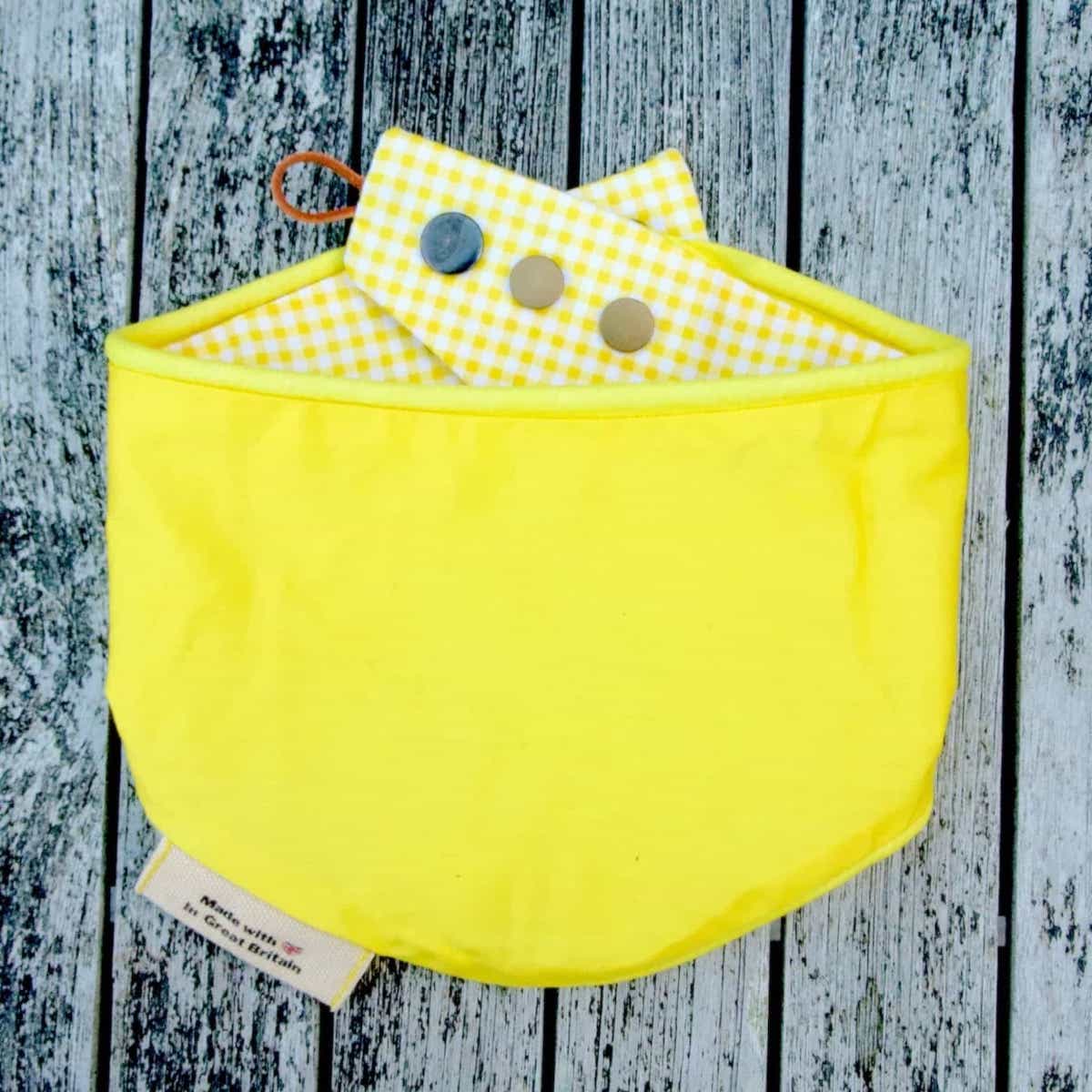plain yellow snap bandana on drift wood