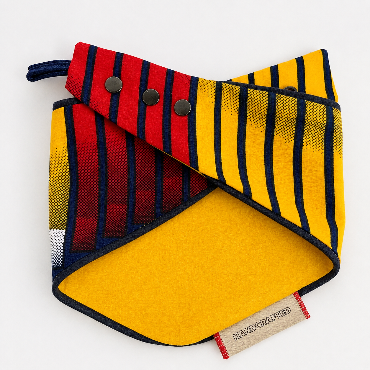 Reversible African tribal print snap-on dog bandana showing smooth yellow cotton reverse