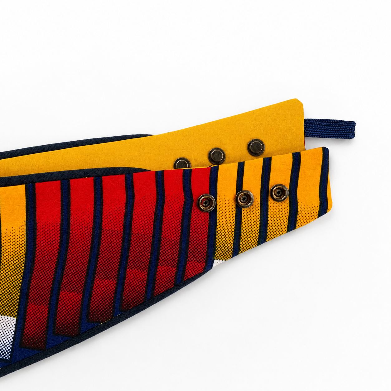 African tribal print snap-on dog bandana showing adjustable metal snaps and yellow cotton lining