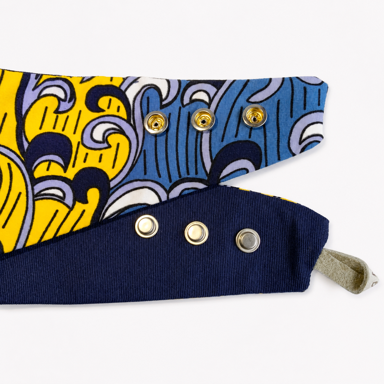 Ankara print snap-on dog bandana showing three adjustable snaps and navy cotton reverse