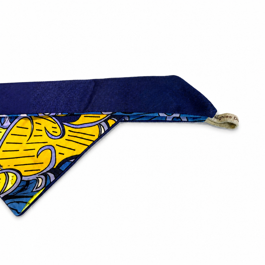 Ankara tie-on dog bandana showing the navy cotton tie and handmade Hughies label
