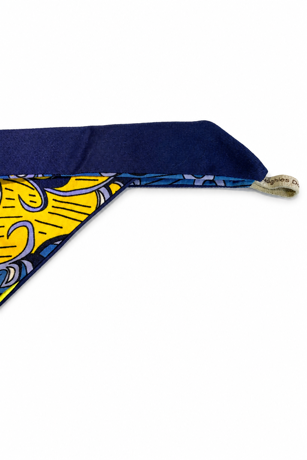 Ankara tie-on dog bandana showing the navy cotton tie and handmade Hughies label
