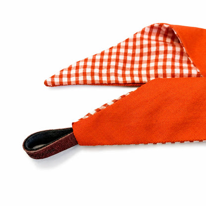Detail of the reversible orange gingham tie-on dog bandana and helper loop