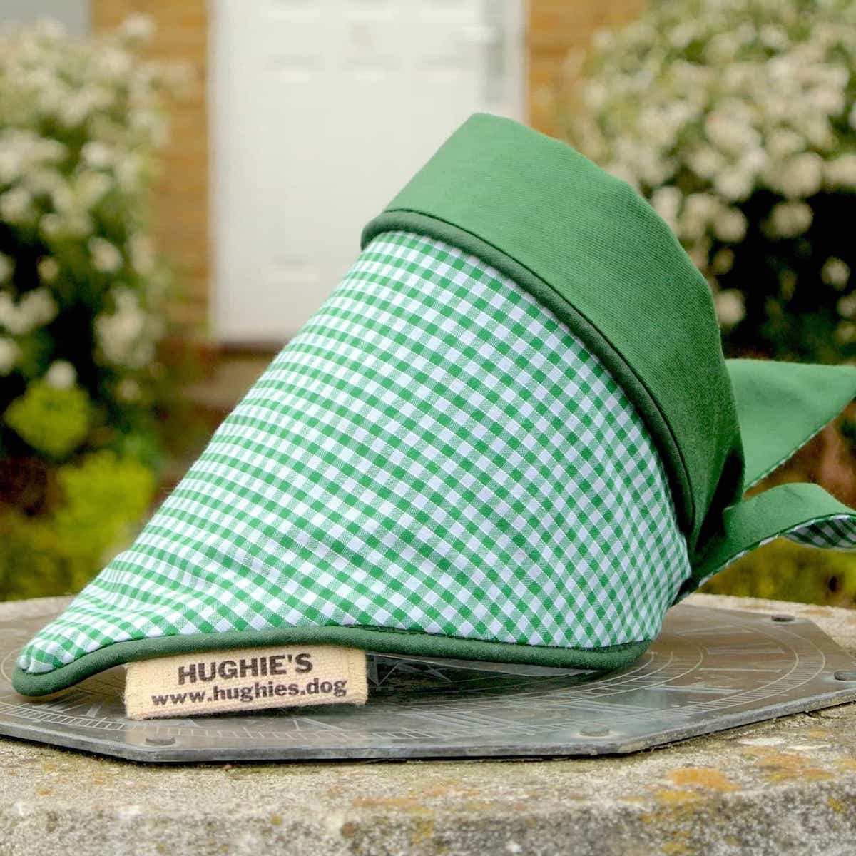 Emerald Green Gingham Tie-on Dog Bandana (reversible) photographed placed on a weather dial in a country garden 