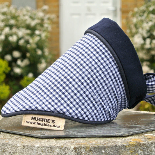 Midnight Blue Gingham Tie-on Dog Bandana (reversible) photographed placed on a weather dial in a country garden 