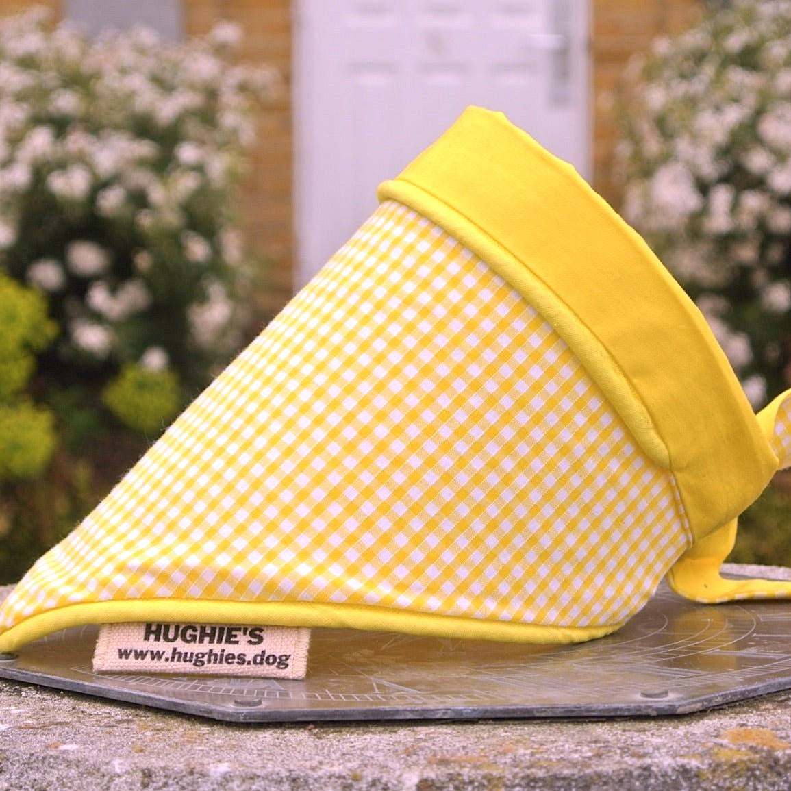 Yellow Gingham bandana placed on a weather dial in a country garden 